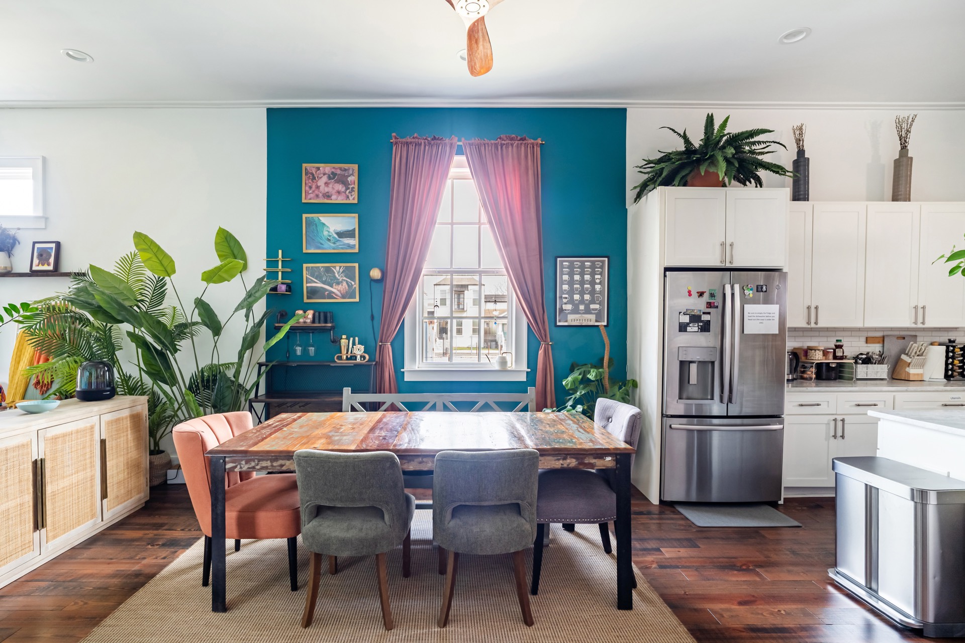 Dining room with teal accent wall and reclaimed wood table