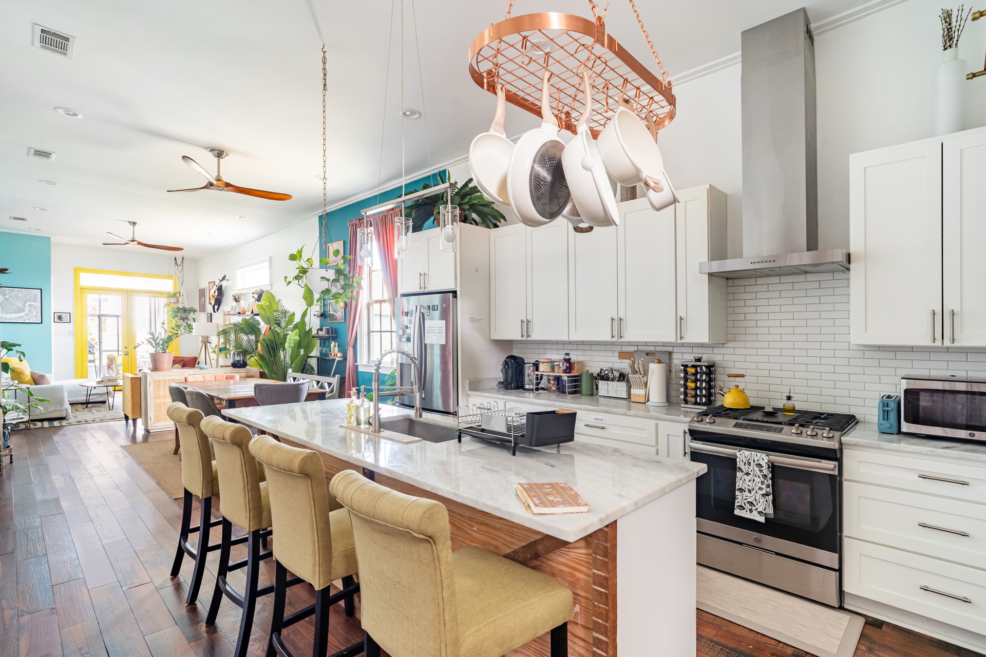 Kitchen with marble island and copper pot rack