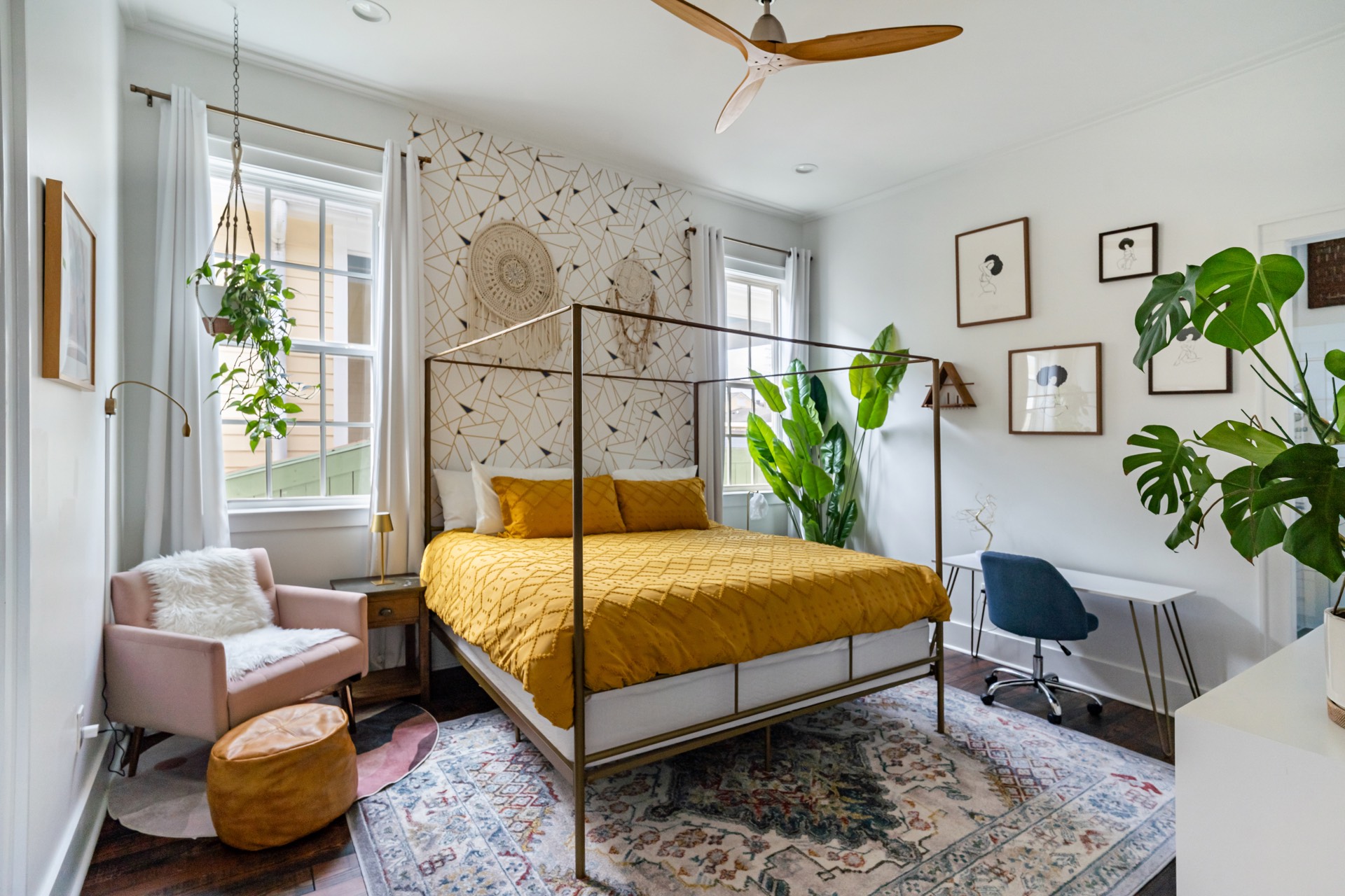 Master bedroom with canopy bed and yellow bedding